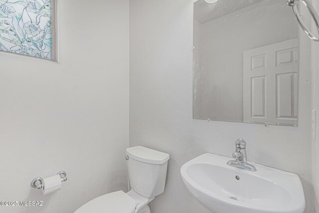 10560 E Forest Falls Ct, Tucson, AZ 85747 - half bath with a sink and toilet