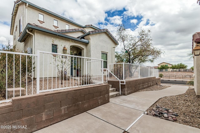 10560 E Forest Falls Ct, Tucson, AZ 85747 - view of property exterior with fence and stucco siding