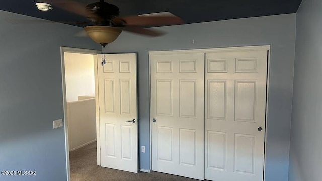 10560 E Forest Falls Ct, Tucson, AZ 85747 - unfurnished bedroom featuring dark carpet, a closet, and baseboards