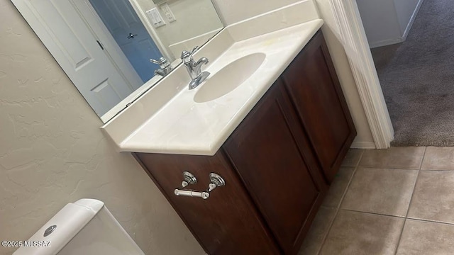 10560 E Forest Falls Ct, Tucson, AZ 85747 - half bath featuring vanity, tile patterned flooring, a textured wall, and toilet