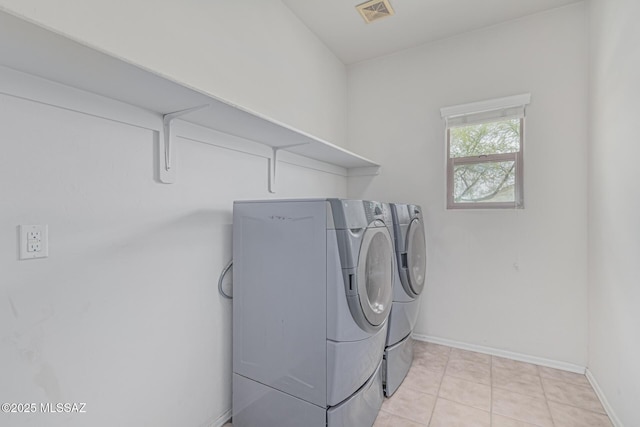 10560 E Forest Falls Ct, Tucson, AZ 85747 - laundry area featuring washer and dryer, baseboards, and light tile patterned flooring