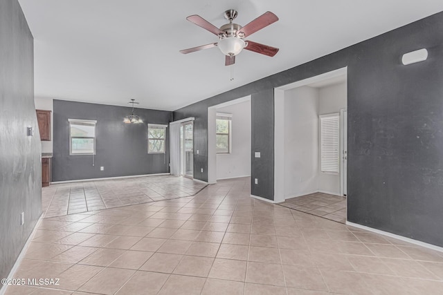 10560 E Forest Falls Ct, Tucson, AZ 85747 - unfurnished room with ceiling fan, baseboards, and light tile patterned floors