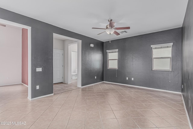10560 E Forest Falls Ct, Tucson, AZ 85747 - spare room with a ceiling fan, light tile patterned floors, and baseboards