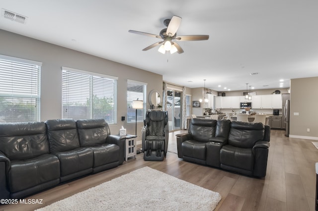 3443 W Tailfeather Dr, Marana, AZ 85658 - living room with ceiling fan, light wood-style flooring, recessed lighting, and baseboards
