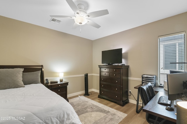 3443 W Tailfeather Dr, Marana, AZ 85658 - bedroom with light wood-type flooring, baseboards, a desk, and ceiling fan