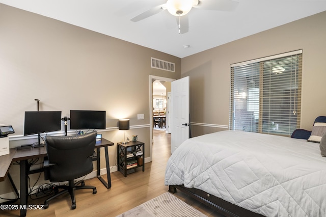 3443 W Tailfeather Dr, Marana, AZ 85658 - bedroom featuring light wood-style floors, a desk, and ceiling fan