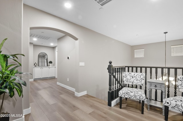 3443 W Tailfeather Dr, Marana, AZ 85658 - hallway featuring arched walkways, light wood finished floors, baseboards, and recessed lighting