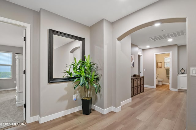 3443 W Tailfeather Dr, Marana, AZ 85658 - corridor with arched walkways, light wood finished floors, baseboards, and recessed lighting