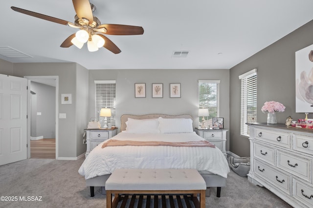 3443 W Tailfeather Dr, Marana, AZ 85658 - bedroom with light carpet, a ceiling fan, and baseboards