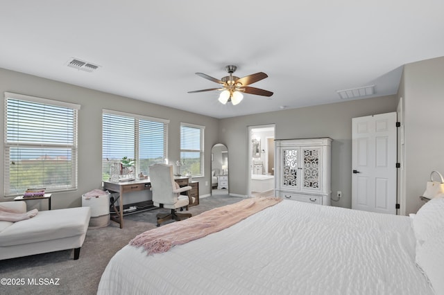 3443 W Tailfeather Dr, Marana, AZ 85658 - carpeted bedroom featuring arched walkways, an office area, baseboards, a ceiling fan, and connected bathroom