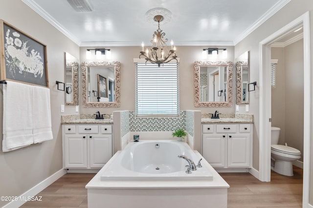 3443 W Tailfeather Dr, Marana, AZ 85658 - bathroom with a chandelier, two vanities, a bath, wood finished floors, and ornamental molding