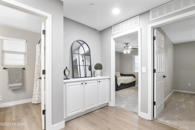 3443 W Tailfeather Dr, Marana, AZ 85658 - full bath featuring wood finished floors, plenty of natural light, a ceiling fan, and toilet