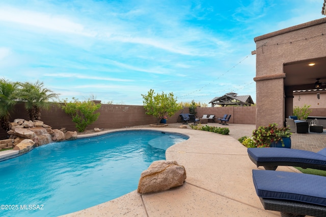 3443 W Tailfeather Dr, Marana, AZ 85658 - view of swimming pool with a patio, a fenced backyard, and an outdoor living space