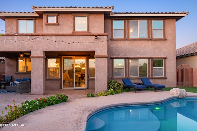 3443 W Tailfeather Dr, Marana, AZ 85658 - rear view of property featuring a patio, an outdoor pool, and stucco siding