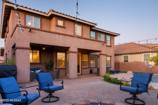 3443 W Tailfeather Dr, Marana, AZ 85658 - rear view of house featuring a tiled roof, stucco siding, and a patio