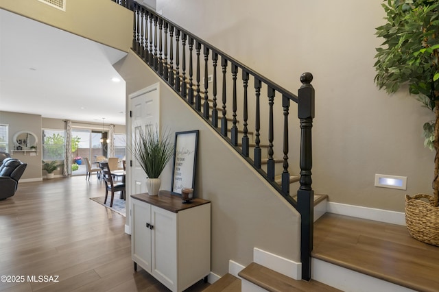 3443 W Tailfeather Dr, Marana, AZ 85658 - stairway featuring wood finished floors, baseboards, and recessed lighting