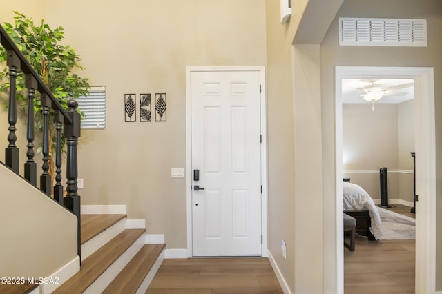 3443 W Tailfeather Dr, Marana, AZ 85658 - entryway with wood finished floors, baseboards, stairs, and ceiling fan