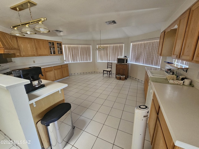 1760 W Airport Rd, Willcox, AZ 85643 - kitchen with a sink, stainless steel microwave, light tile patterned floors, and light countertops