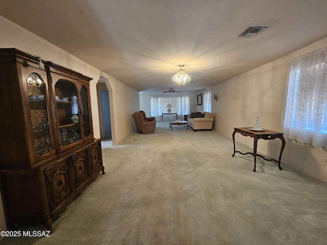 1760 W Airport Rd, Willcox, AZ 85643 - living area featuring light carpet, a chandelier, and arched walkways