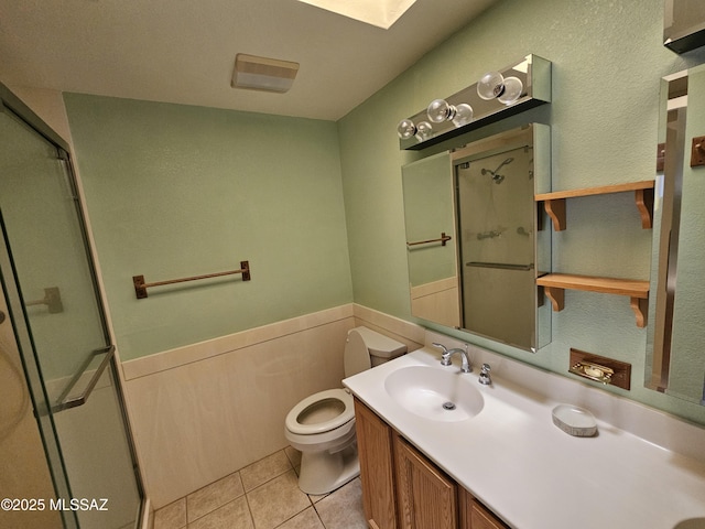 1760 W Airport Rd, Willcox, AZ 85643 - bathroom featuring toilet, a shower stall, vanity, tile patterned flooring, and a skylight