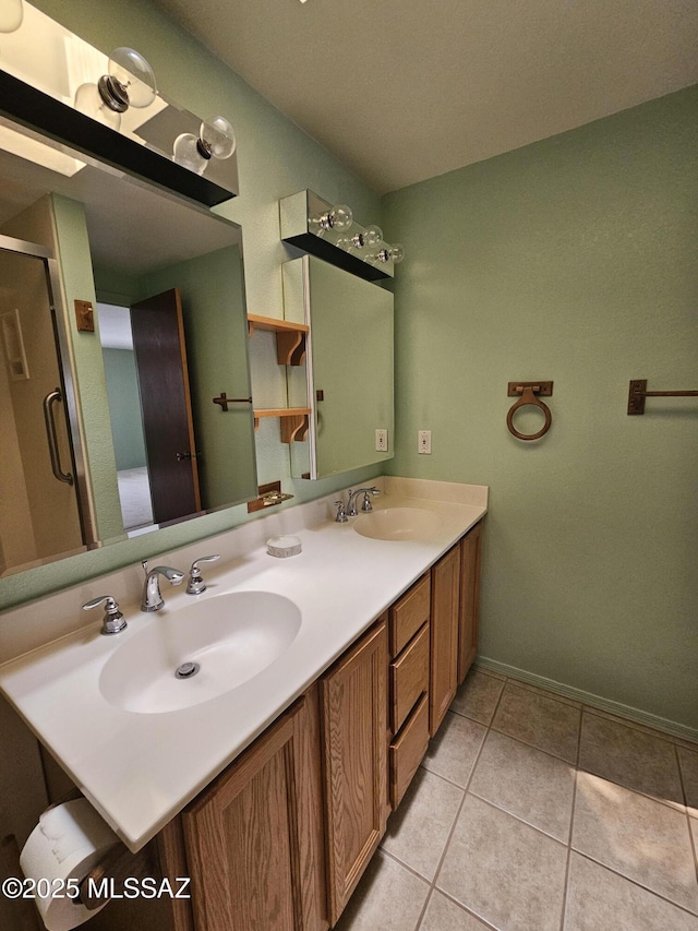 1760 W Airport Rd, Willcox, AZ 85643 - full bathroom with double vanity, tile patterned flooring, a stall shower, and baseboards