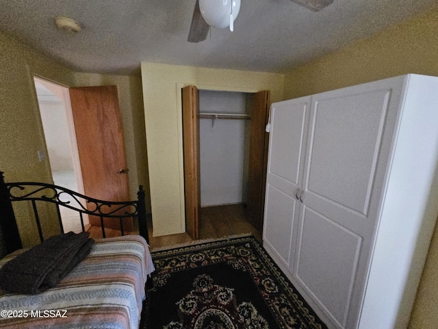 1760 W Airport Rd, Willcox, AZ 85643 - bedroom featuring a textured ceiling, a closet, ceiling fan, and wood finished floors