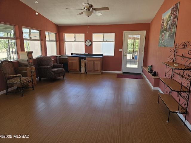 1760 W Airport Rd, Willcox, AZ 85643 - living room with a ceiling fan, baseboards, wood finished floors, and vaulted ceiling