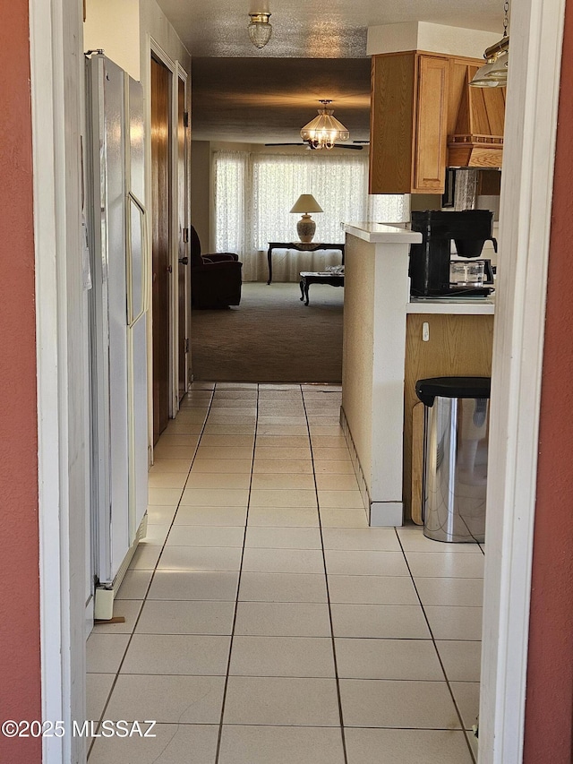1760 W Airport Rd, Willcox, AZ 85643 - kitchen featuring freestanding refrigerator, light tile patterned floors, open floor plan, and light countertops