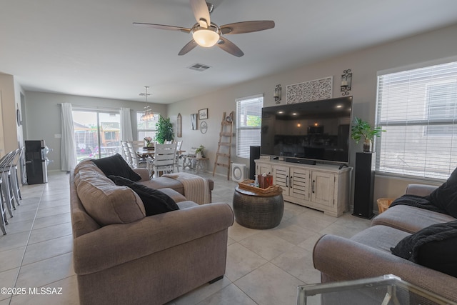 8839 N Hardy Preserve Loop, Tucson, AZ 85742 - living room featuring light tile patterned flooring, a ceiling fan, and healthy amount of natural light