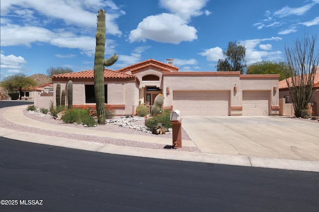 1265 Quail Point Ct, Tucson, AZ 85745 - mediterranean / spanish-style home with stucco siding, a garage, concrete driveway, and a tiled roof