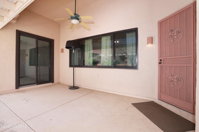 1265 Quail Point Ct, Tucson, AZ 85745 - view of exterior entry with stucco siding, a ceiling fan, and a patio