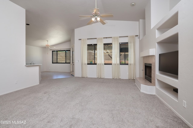 1265 Quail Point Ct, Tucson, AZ 85745 - unfurnished living room with ceiling fan, a tiled fireplace, lofted ceiling, and carpet floors