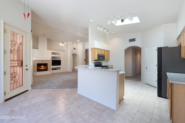 1265 Quail Point Ct, Tucson, AZ 85745 - kitchen featuring arched walkways, gas stove, freestanding refrigerator, light tile patterned flooring, and track lighting