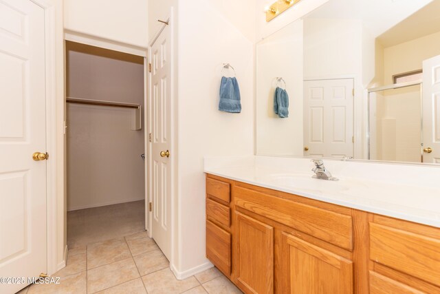 4161 W Diamond Butte Ct, Tucson, AZ 85745 - full bathroom featuring a shower stall, tile patterned floors, vanity, and baseboards
