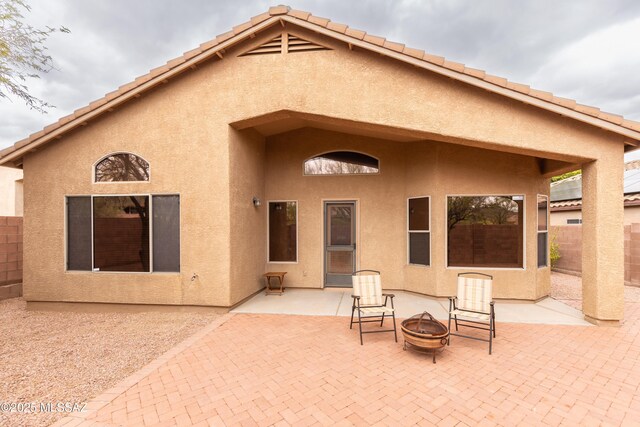 4161 W Diamond Butte Ct, Tucson, AZ 85745 - rear view of house featuring a fire pit, fence, a patio area, and stucco siding
