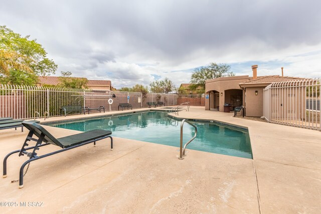 4161 W Diamond Butte Ct, Tucson, AZ 85745 - community pool with a patio and fence