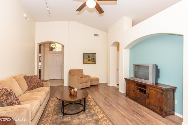 4161 W Diamond Butte Ct, Tucson, AZ 85745 - living area featuring arched walkways, a ceiling fan, wood finished floors, high vaulted ceiling, and track lighting