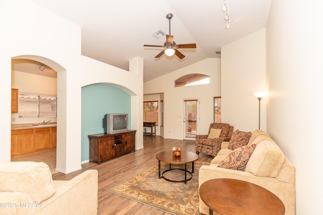 4161 W Diamond Butte Ct, Tucson, AZ 85745 - living area with vaulted ceiling, light wood-style floors, a ceiling fan, and baseboards