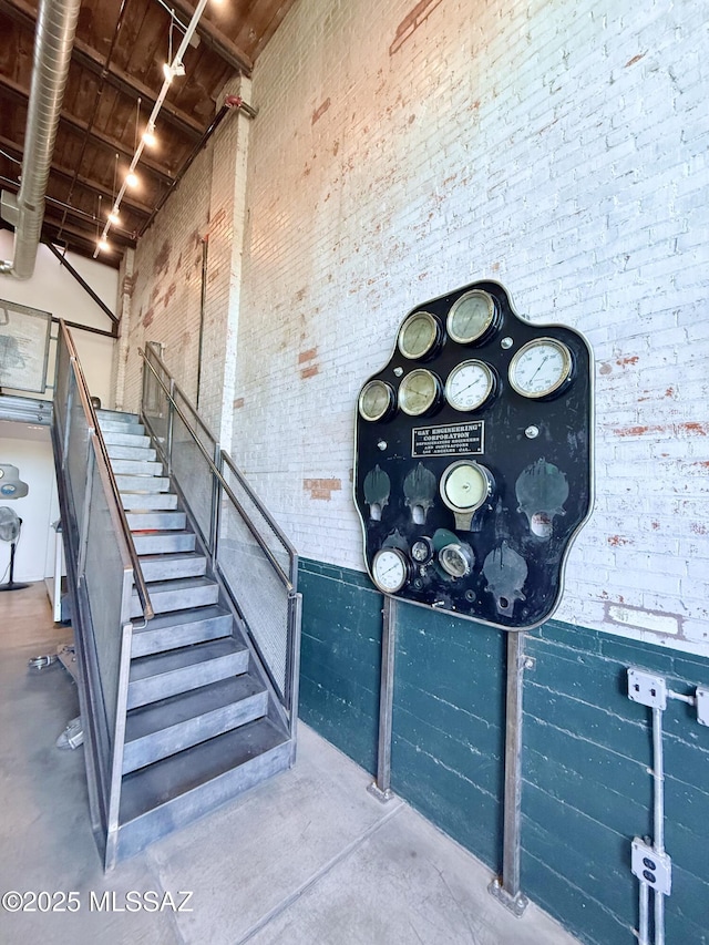 1001 E 17th St Apt 106, Tucson, AZ 85719 - stairway with finished concrete floors, brick wall, and a high ceiling