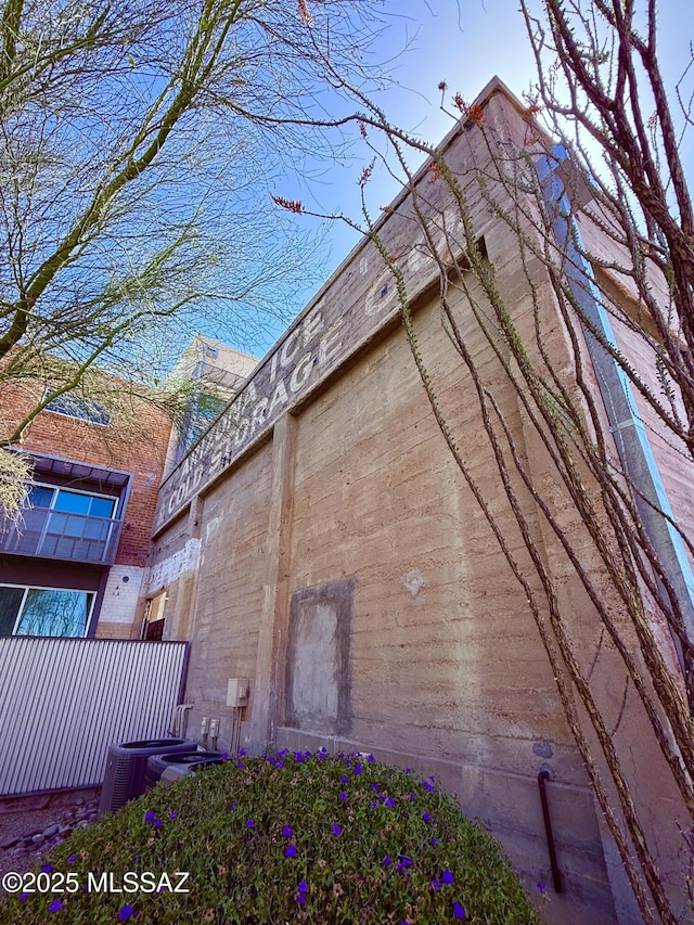 1001 E 17th St Apt 106, Tucson, AZ 85719 - view of side of home featuring central AC and fence