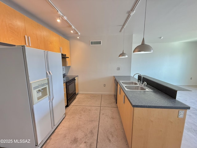 1001 E 17th St Apt 106, Tucson, AZ 85719 - kitchen featuring black appliances, track lighting, a sink, dark countertops, and baseboards
