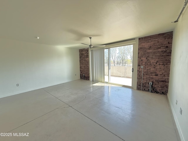 1001 E 17th St Apt 106, Tucson, AZ 85719 - unfurnished room featuring finished concrete floors, ceiling fan, brick wall, and baseboards