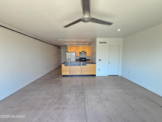 1001 E 17th St Apt 106, Tucson, AZ 85719 - unfurnished living room featuring concrete flooring, baseboards, ceiling fan, and a garage