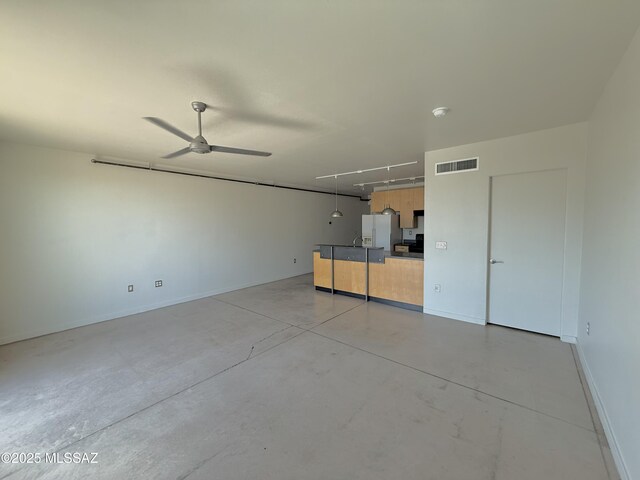 1001 E 17th St Apt 106, Tucson, AZ 85719 - unfurnished room featuring concrete floors, baseboards, and a ceiling fan