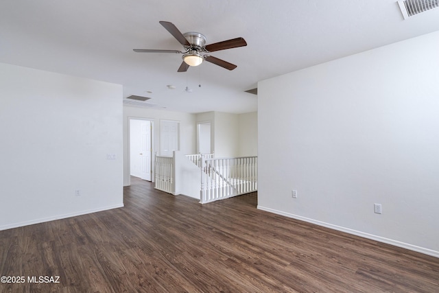 803 W Calle Muro Fuerte Dr, Sahuarita, AZ 85629 - spare room with dark wood-type flooring, a ceiling fan, and baseboards