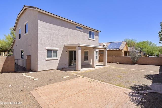 803 W Calle Muro Fuerte Dr, Sahuarita, AZ 85629 - rear view of house with stucco siding, a fenced backyard, and a patio area
