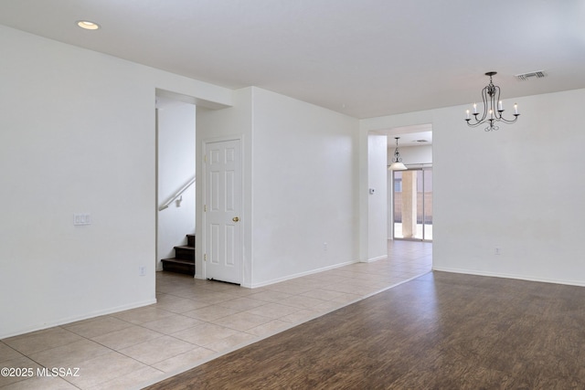 803 W Calle Muro Fuerte Dr, Sahuarita, AZ 85629 - unfurnished room featuring light wood-style flooring, a chandelier, stairs, baseboards, and recessed lighting