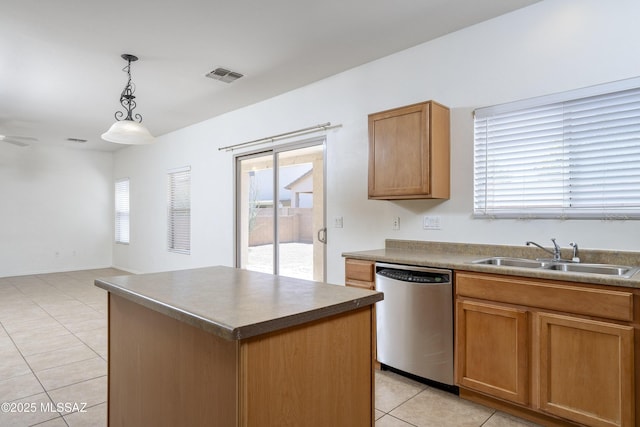 803 W Calle Muro Fuerte Dr, Sahuarita, AZ 85629 - kitchen with stainless steel dishwasher, a sink, light tile patterned floors, pendant lighting, and a kitchen island
