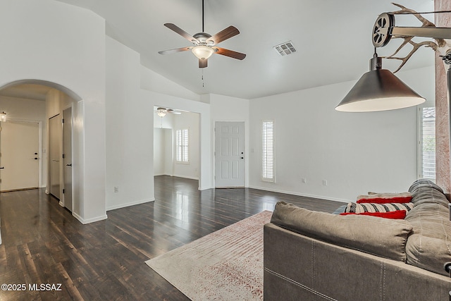 living area featuring arched walkways, ceiling fan, plenty of natural light, lofted ceiling, and wood finished floors