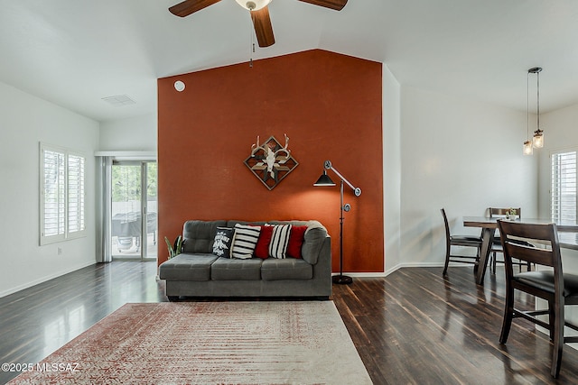 living room with wood finished floors, a ceiling fan, baseboards, and vaulted ceiling